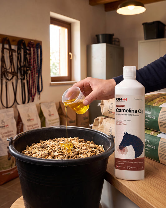 Camelina Oil measured with the cup and poured over the feed