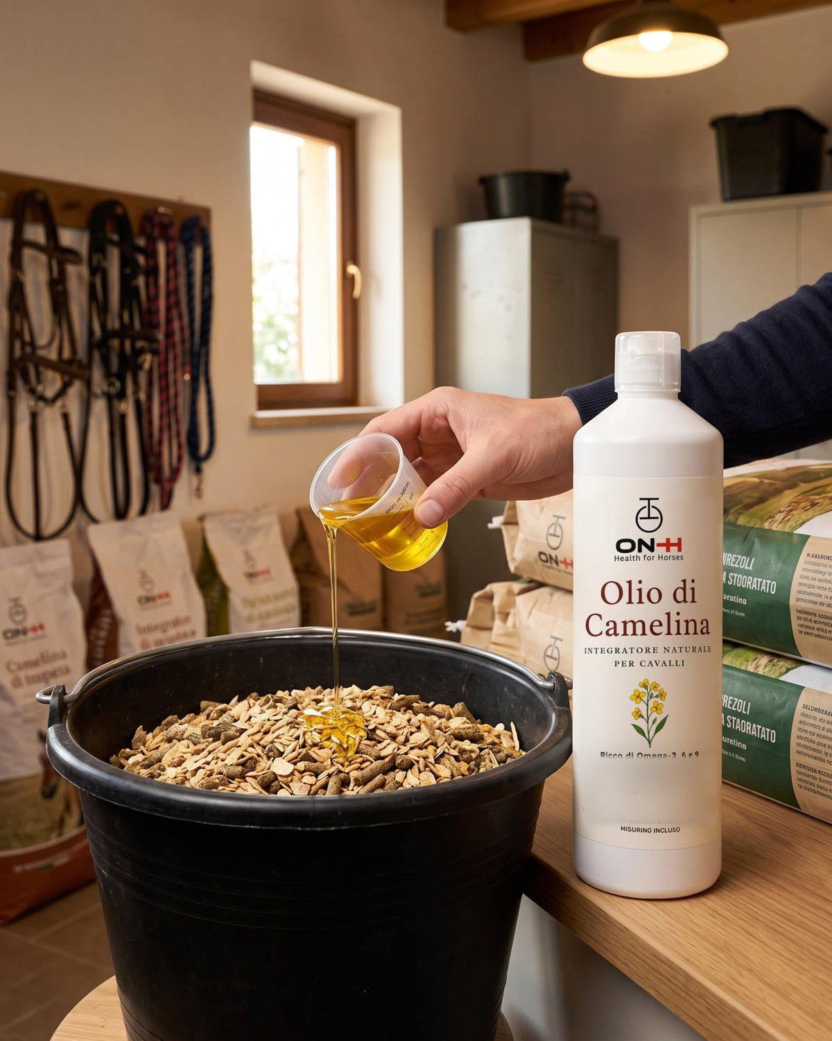 Olio di Camelina dosato col misurino e versato sul mangime